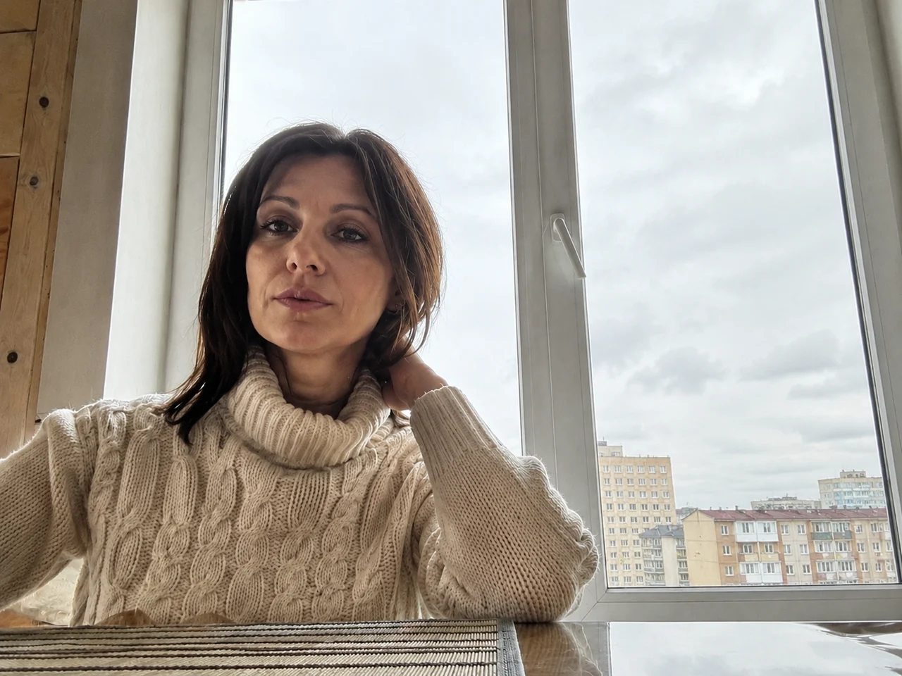 Девушка у окна: лицо и фигура вытянуты из тени, за стеклом вместо белого пятна снова видна улица